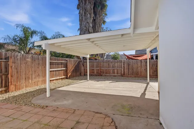 an aerial view of a house with garden space and street view