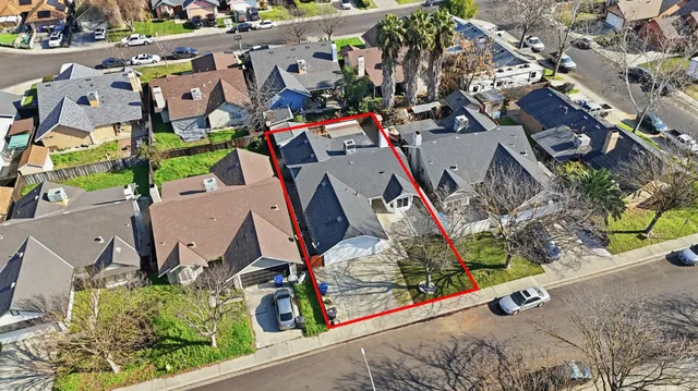 an aerial view of residential house with outdoor space and parking