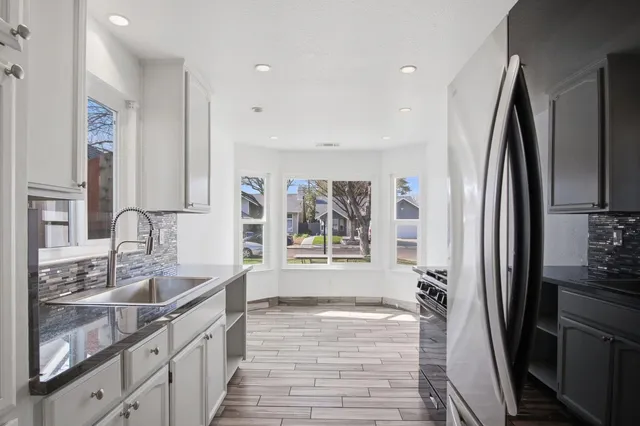 a bathroom with a double vanity sink a mirror and a shower