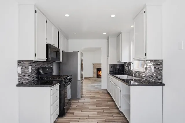 a kitchen with stainless steel appliances a refrigerator sink and stove