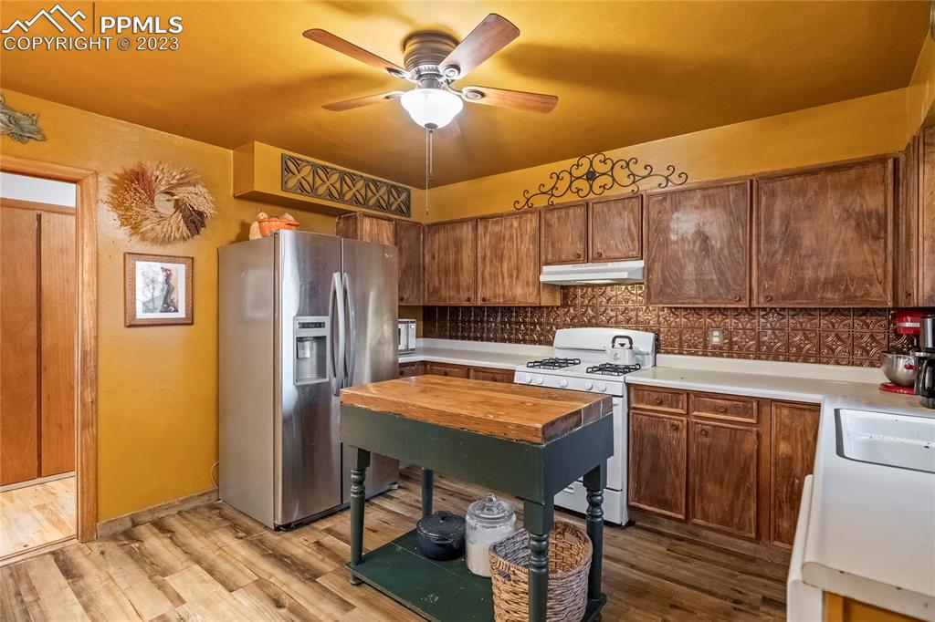 2905 Lauppe Road Yoder, CO 80864 - Photo 17 of 35 a kitchen with stainless steel appliances granite countertop a sink refrigerator and cabinets