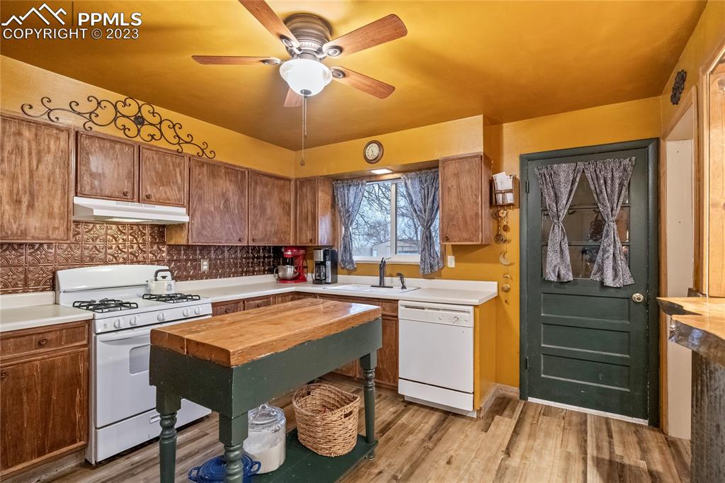 2905 Lauppe Road Yoder, CO 80864 - Photo 18 of 35 a kitchen with a stove a sink and cabinets