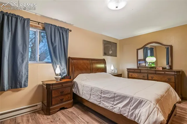 a bedroom with a bed and a dresser with mirror