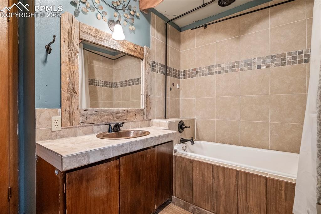 2905 Lauppe Road Yoder, CO 80864 - Photo 24 of 35 a bathroom with a sink and a mirror