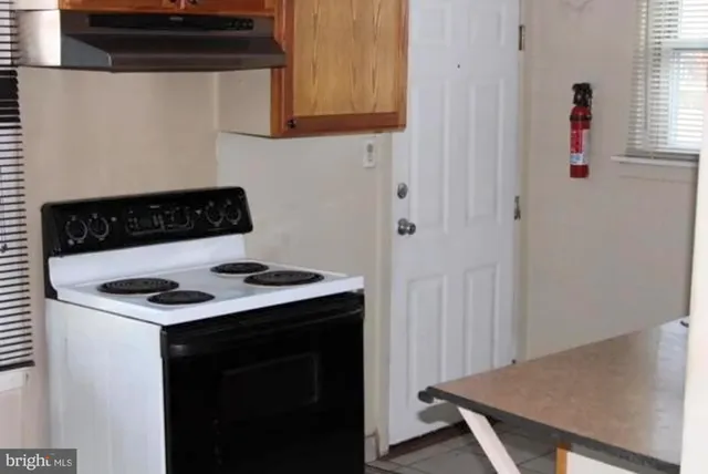 a kitchen with a stove and a refrigerator