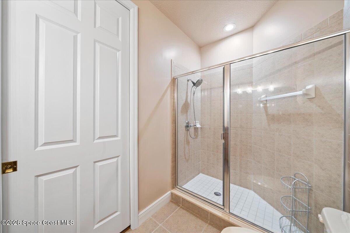6005 Highway 1, Unit 101 Rockledge, FL 32955 - Photo 27 of 57 a bathroom with a glass shower door