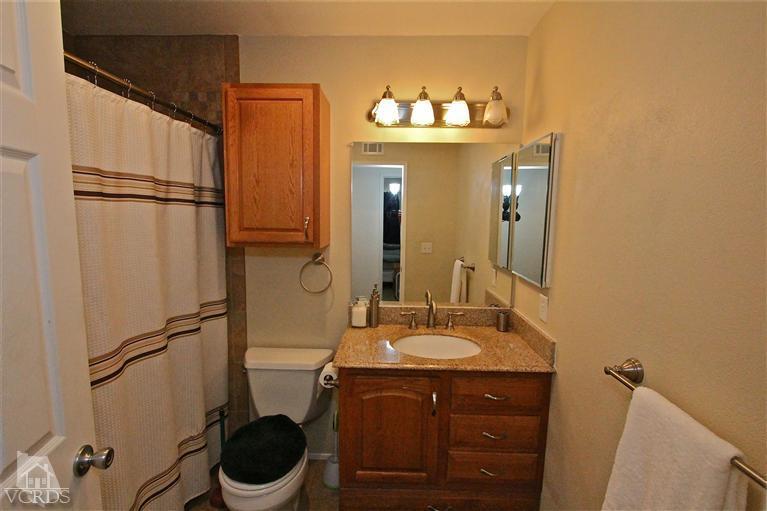 1025 Roldan Avenue Simi Valley, CA 93065 - Photo 14 of 28 a bathroom with a sink vanity mirror and toilet