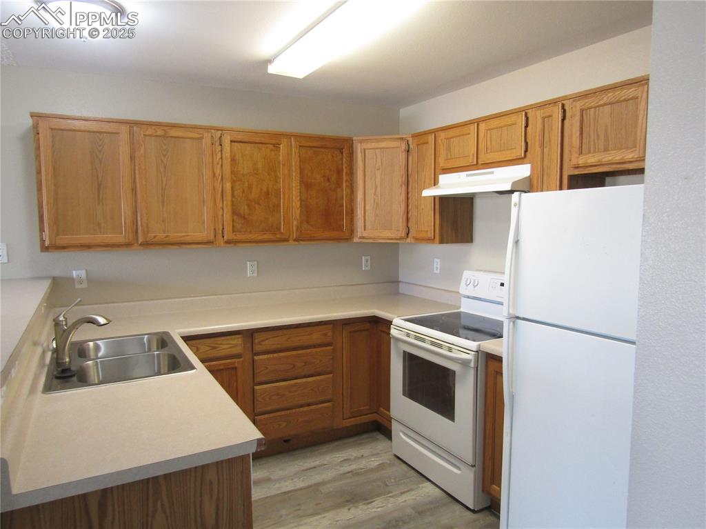 331 Trapper Lane Fountain, CO 80817 - Photo 5 of 10 a kitchen with a white cabinets and white appliances