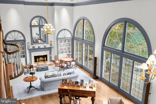 a living room with fireplace furniture and a large window