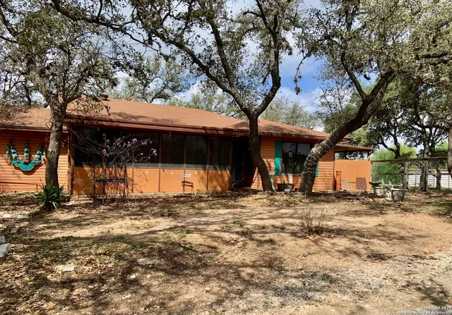 a view of a house with a large tree
