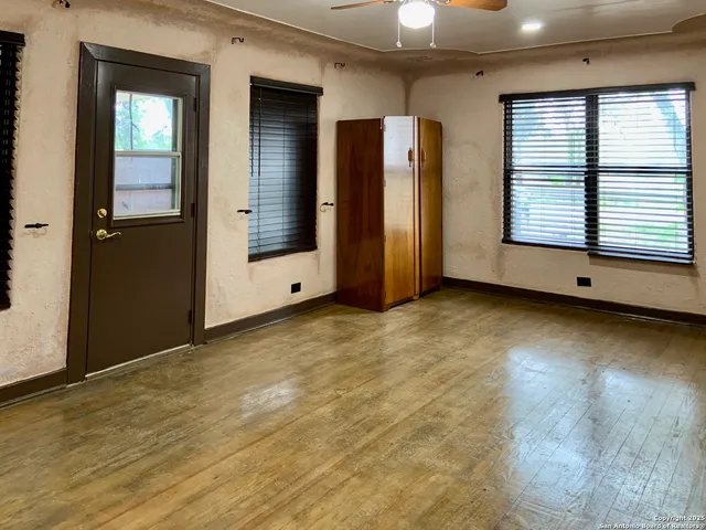 an empty room with windows and closet