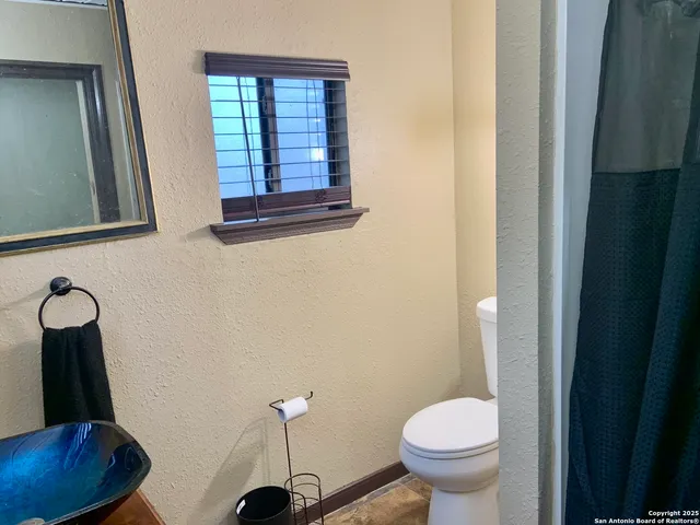a bathroom with a toilet and a sink