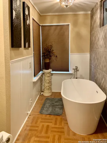 a bathroom with a bathtub and shower
