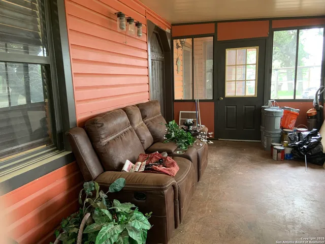 a living room filled with furniture and a large window