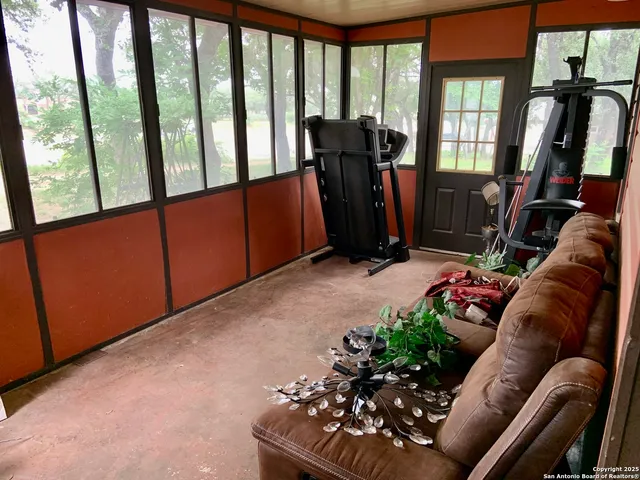 a living room with furniture and a floor to ceiling window