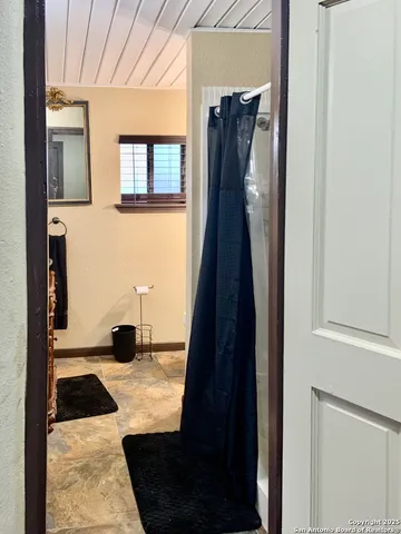 a living room with fireplace furniture and a window