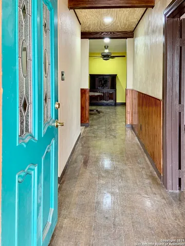 a hallway with painting on the wall