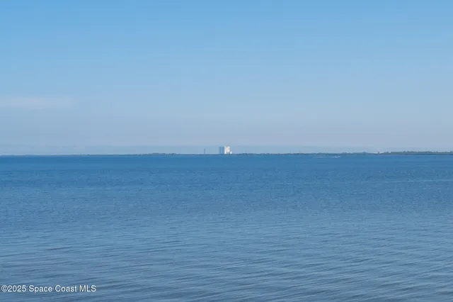 a view of an empty room and wooden floor