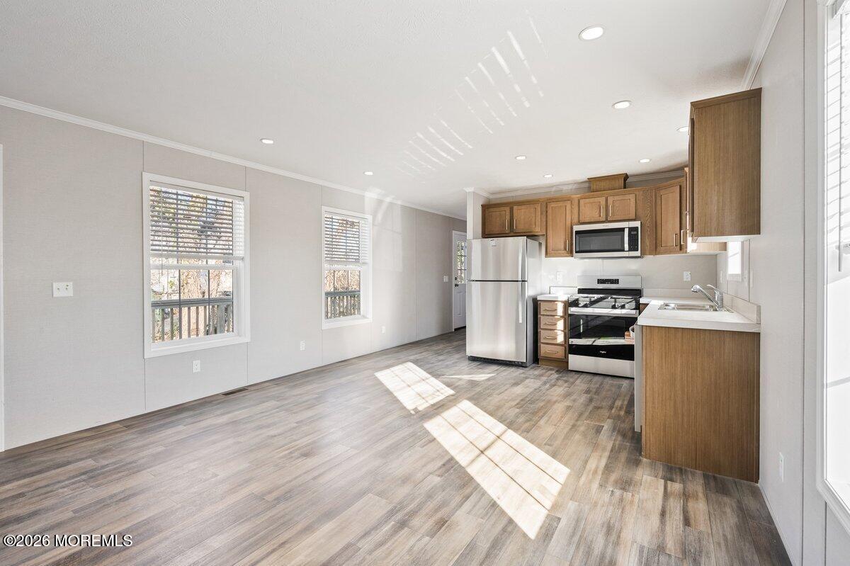 1820 State Rte 35, Unit 16 Wall, NJ 07719 - Photo 11 of 24 a kitchen with stainless steel appliances a refrigerator and a stove top oven