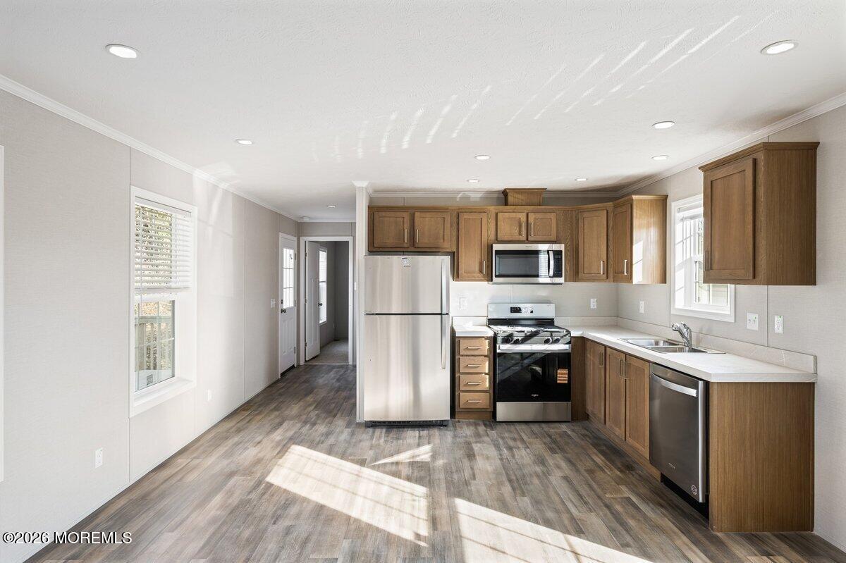 1820 State Rte 35, Unit 16 Wall, NJ 07719 - Photo 12 of 24 a kitchen with a sink a refrigerator and wooden floor