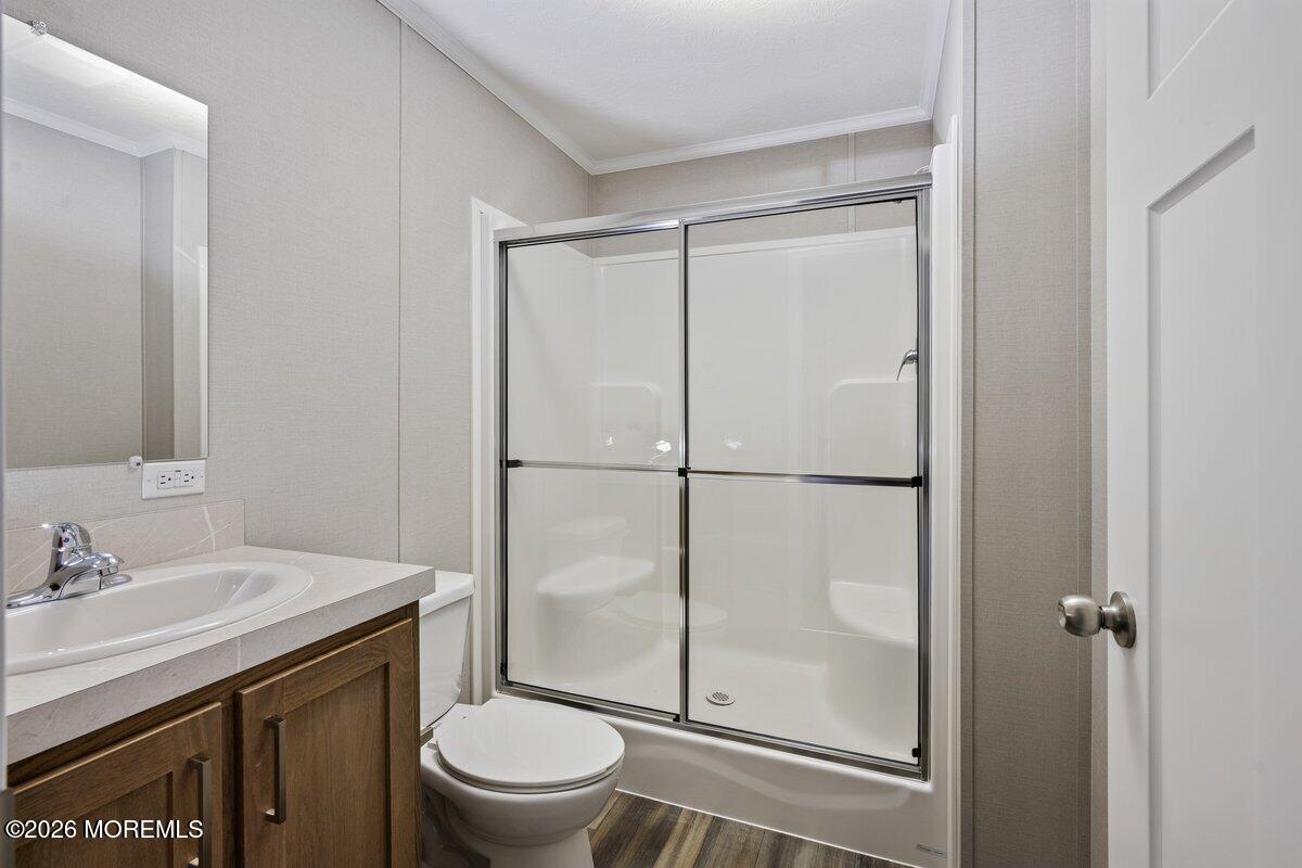 1820 State Rte 35, Unit 16 Wall, NJ 07719 - Photo 15 of 24 a bathroom with a granite countertop sink toilet and shower