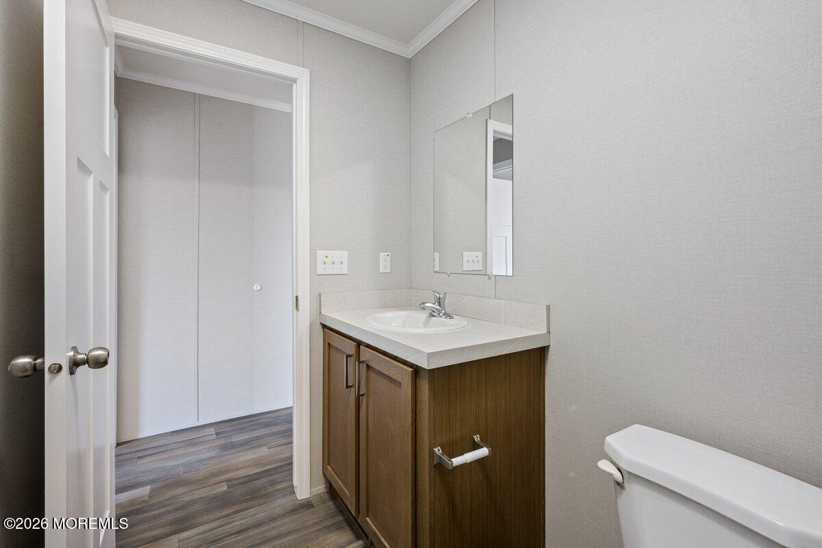 1820 State Rte 35, Unit 16 Wall, NJ 07719 - Photo 19 of 24 a bathroom with a sink toilet and a mirror