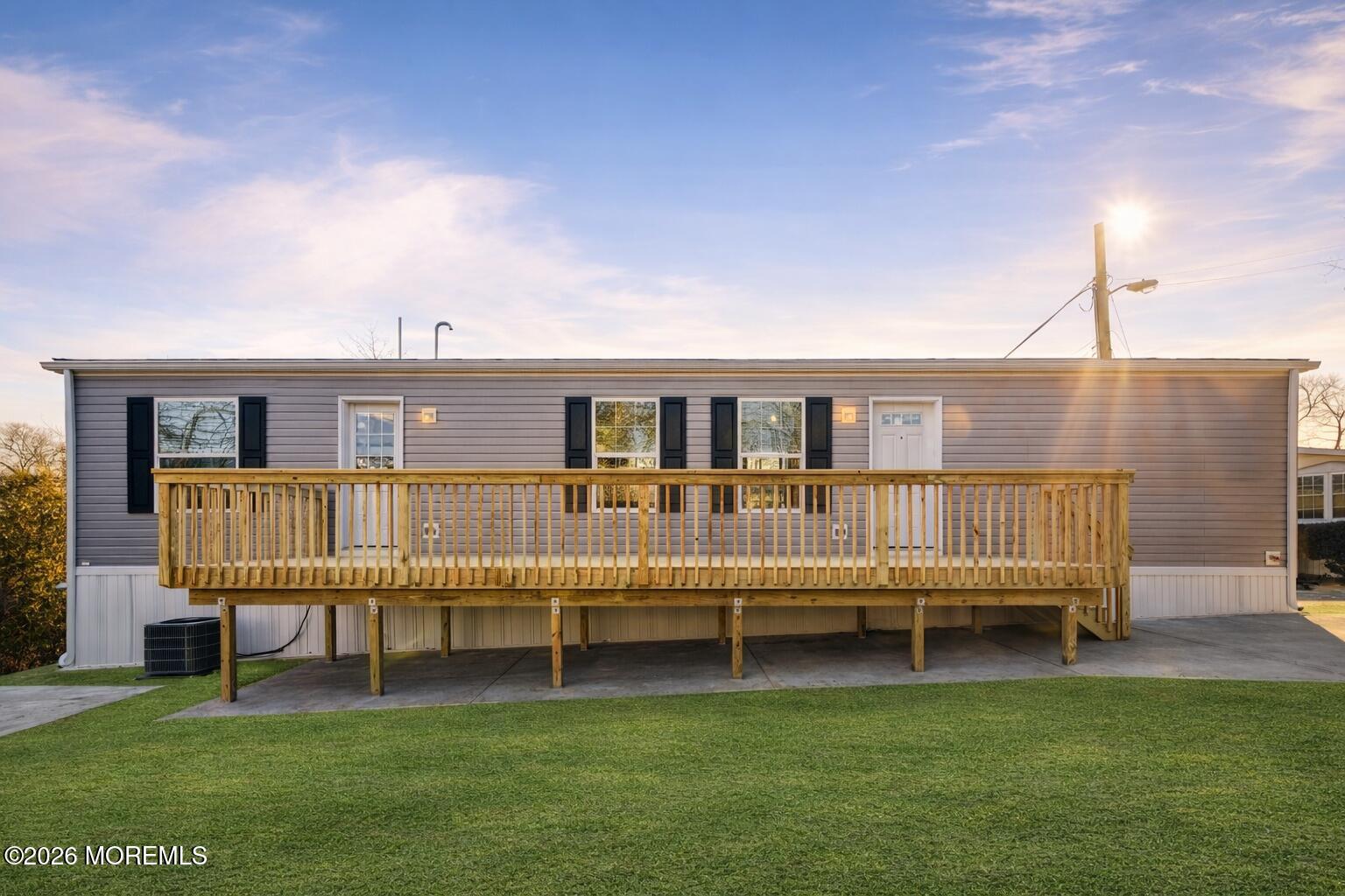 1820 State Rte 35, Unit 16 Wall, NJ 07719 - Photo 24 of 24 a view of a house with a deck and a yard