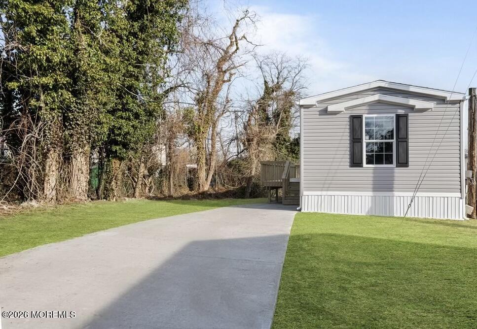1820 State Rte 35, Unit 16 Wall, NJ 07719 - Photo 3 of 24 a view of a backyard with large trees