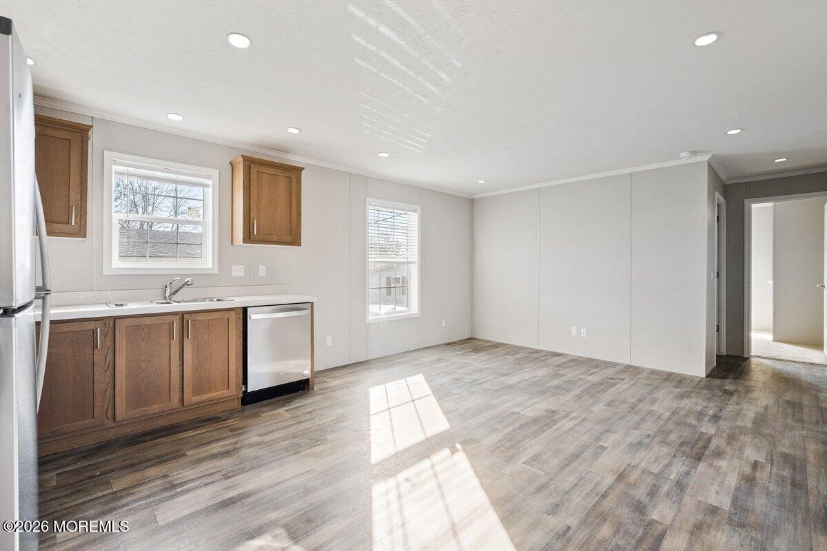 1820 State Rte 35, Unit 16 Wall, NJ 07719 - Photo 7 of 24 a view of a kitchen with a sink and dishwasher with wooden floor