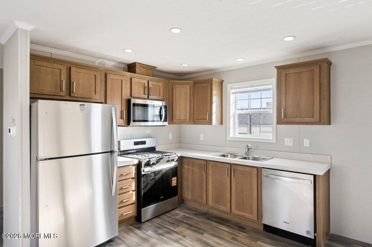 1820 State Rte 35, Unit 16 Wall, NJ 07719 - Photo 8 of 24 a kitchen with stainless steel appliances granite countertop a refrigerator a stove a sink and a refrigerator with wooden floor