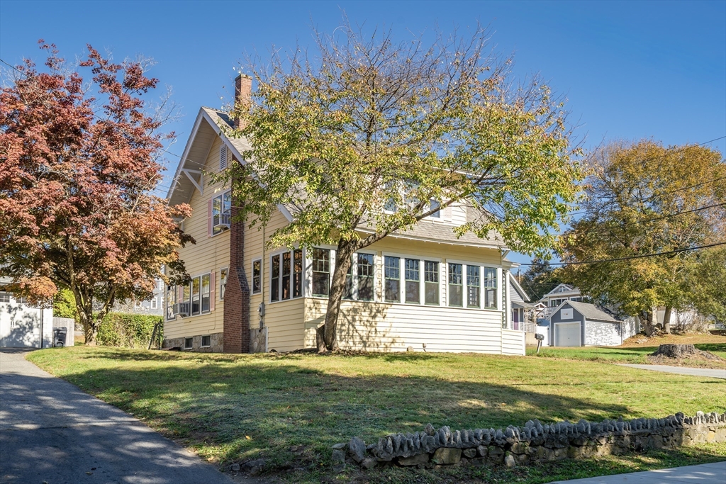 a front view of a house with a garden