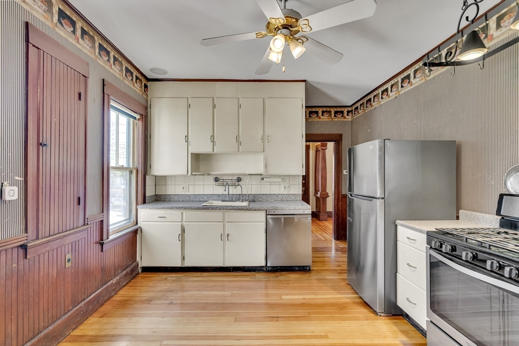 219 Pelham Street Methuen, MA 01844 - Photo 18 of 39 a kitchen with stainless steel appliances granite countertop a stove a refrigerator and a sink