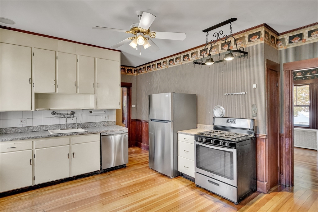 219 Pelham Street Methuen, MA 01844 - Photo 19 of 39 a kitchen with stainless steel appliances a stove a sink and a refrigerator