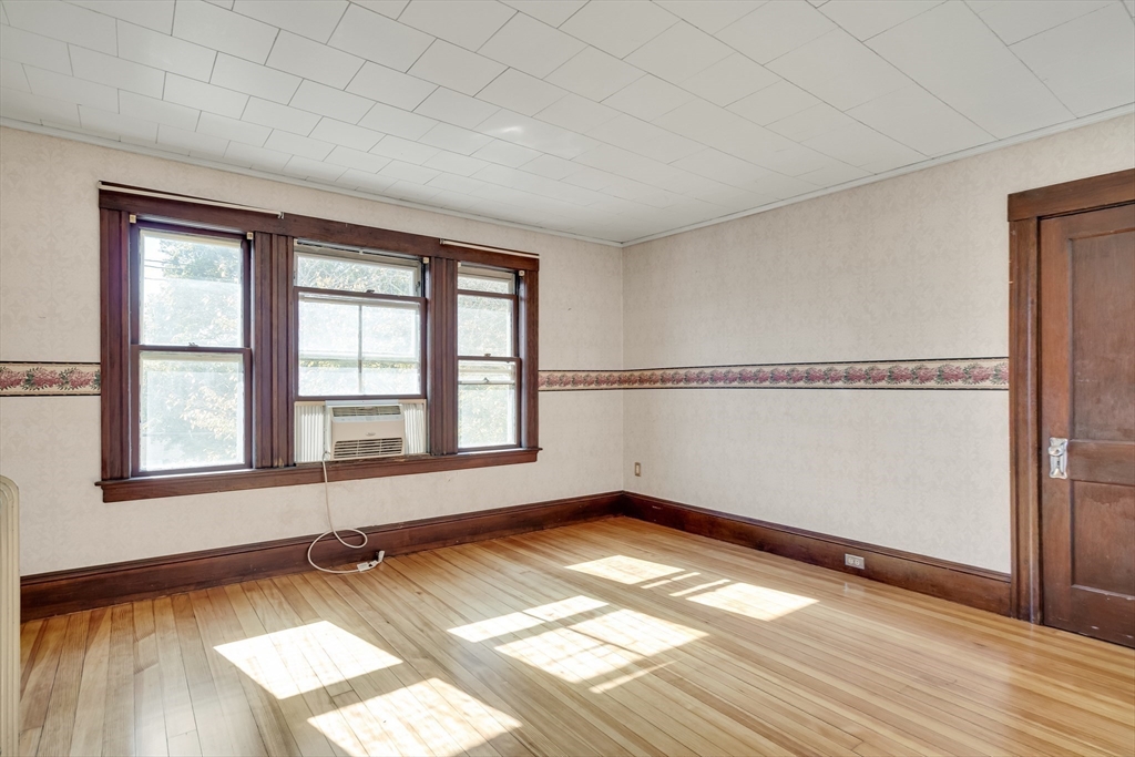 219 Pelham Street Methuen, MA 01844 - Photo 27 of 39 an empty room with wooden floor and windows