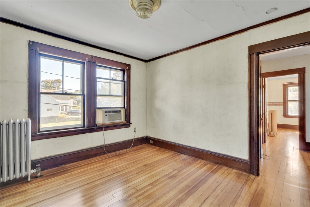 219 Pelham Street Methuen, MA 01844 - Photo 32 of 39 an empty room with wooden floor and windows