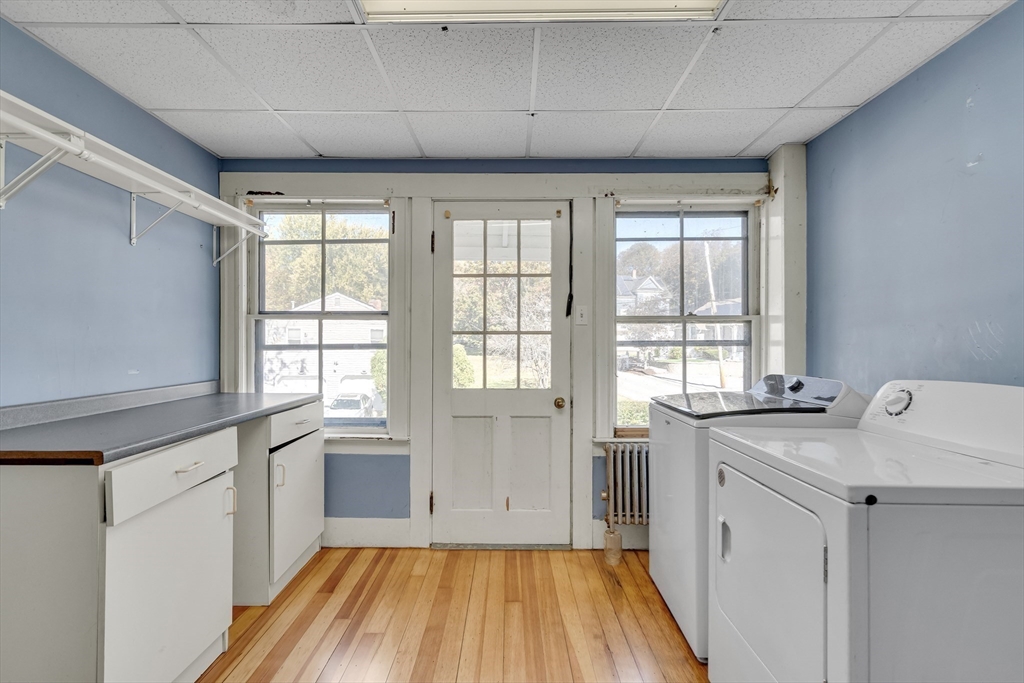 219 Pelham Street Methuen, MA 01844 - Photo 33 of 39 a view of a kitchen with a sink dishwasher and wooden floor