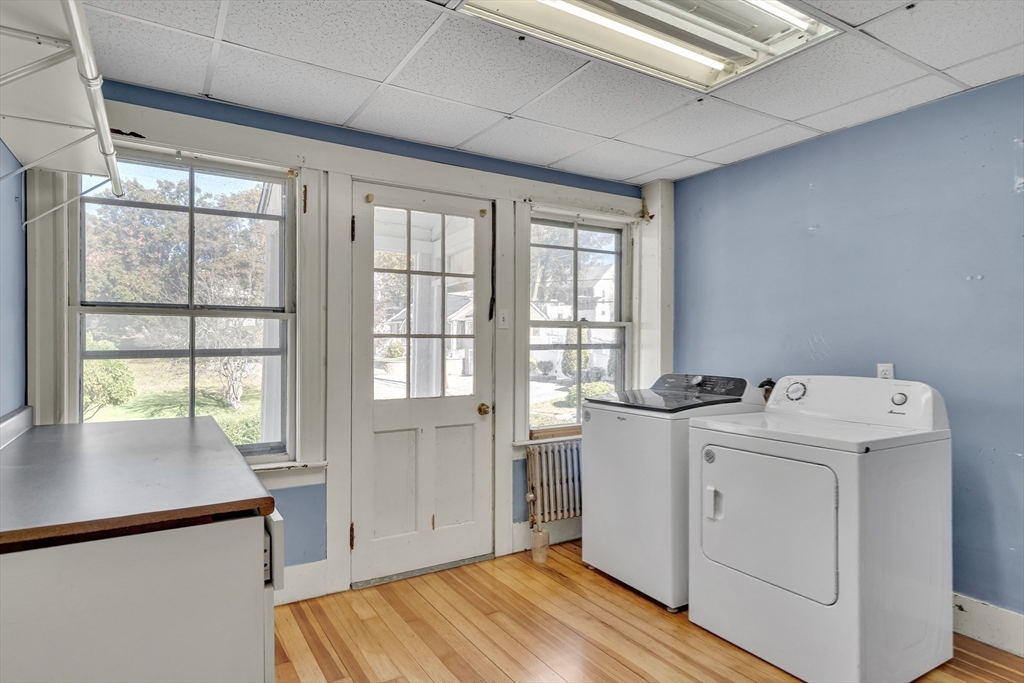 219 Pelham Street Methuen, MA 01844 - Photo 34 of 39 a view of a kitchen with refrigerator and wooden floor