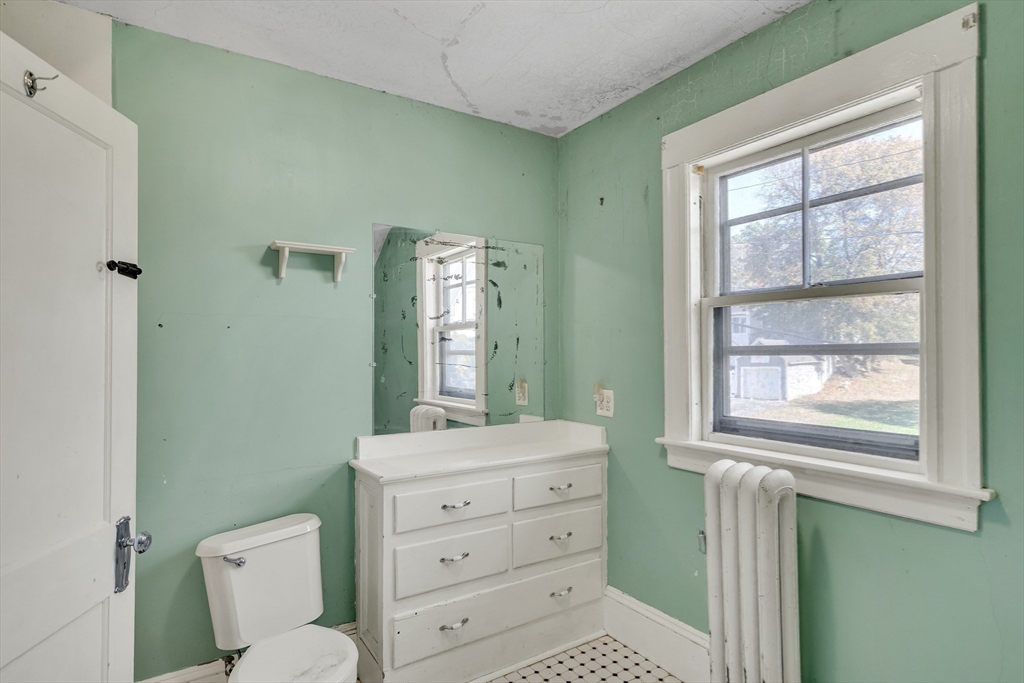 219 Pelham Street Methuen, MA 01844 - Photo 36 of 39 a bathroom with a toilet a sink a vanity and mirror