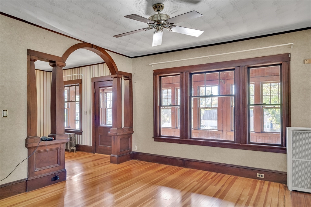 219 Pelham Street Methuen, MA 01844 - Photo 6 of 39 an empty room with wooden floor fan and windows
