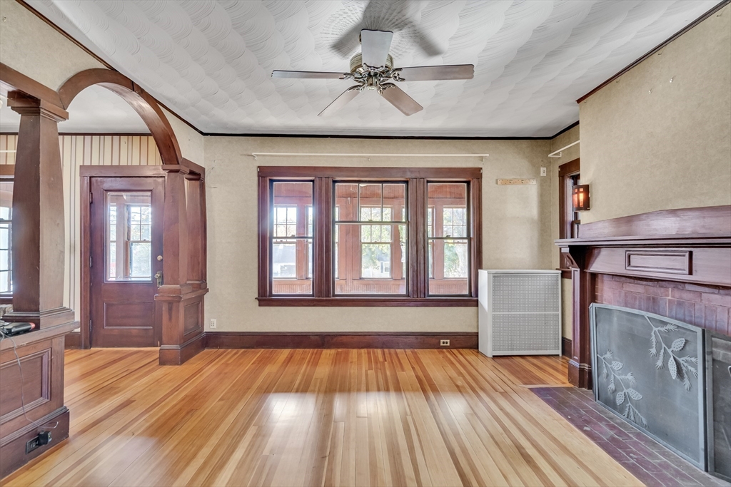 219 Pelham Street Methuen, MA 01844 - Photo 10 of 39 a view of hallway with wooden floor and fireplace