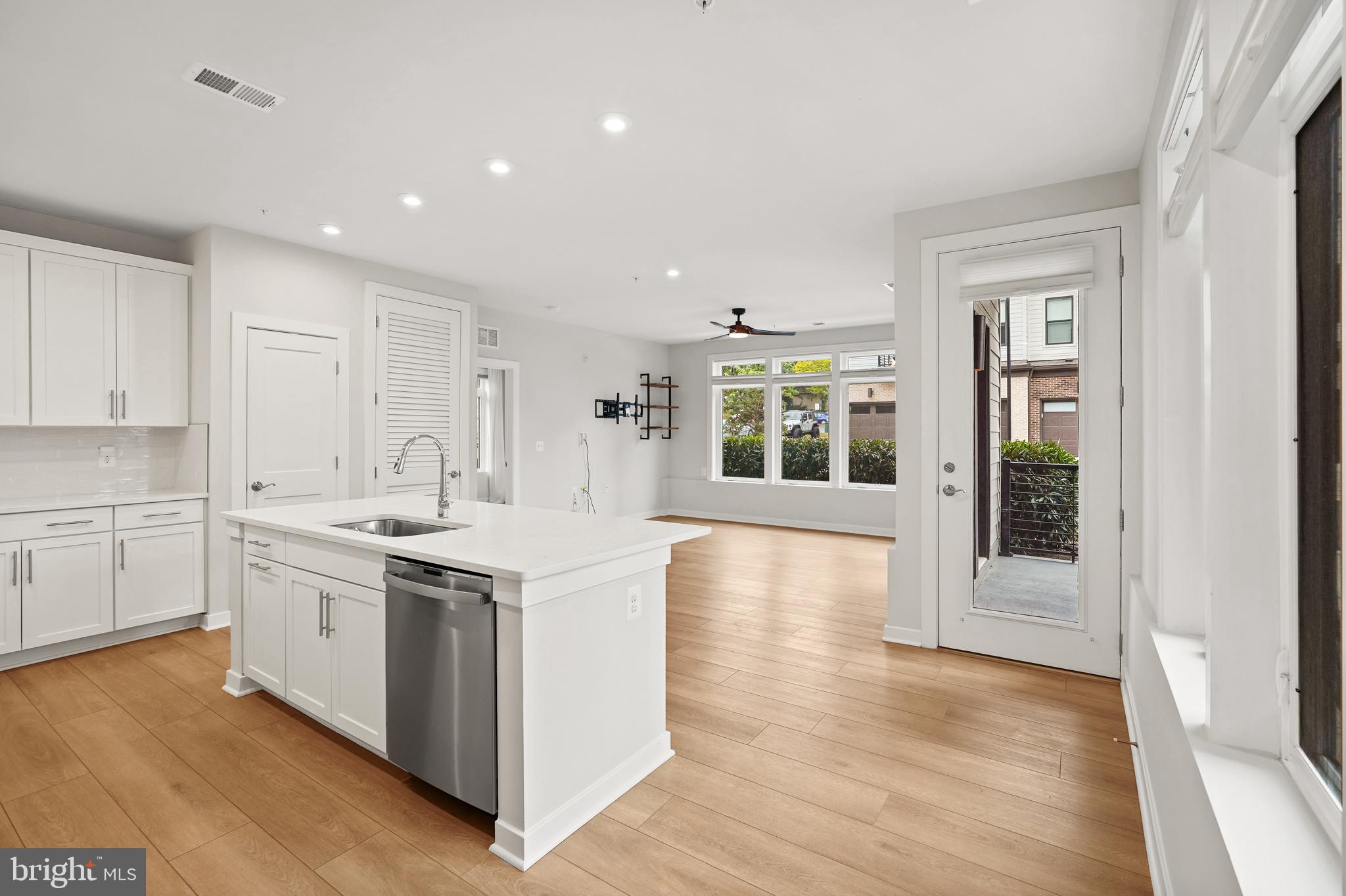 1675 Bandit Loop, Unit 107B Reston, VA 20190 - Photo 1 of 36 a kitchen with a sink stove and cabinets