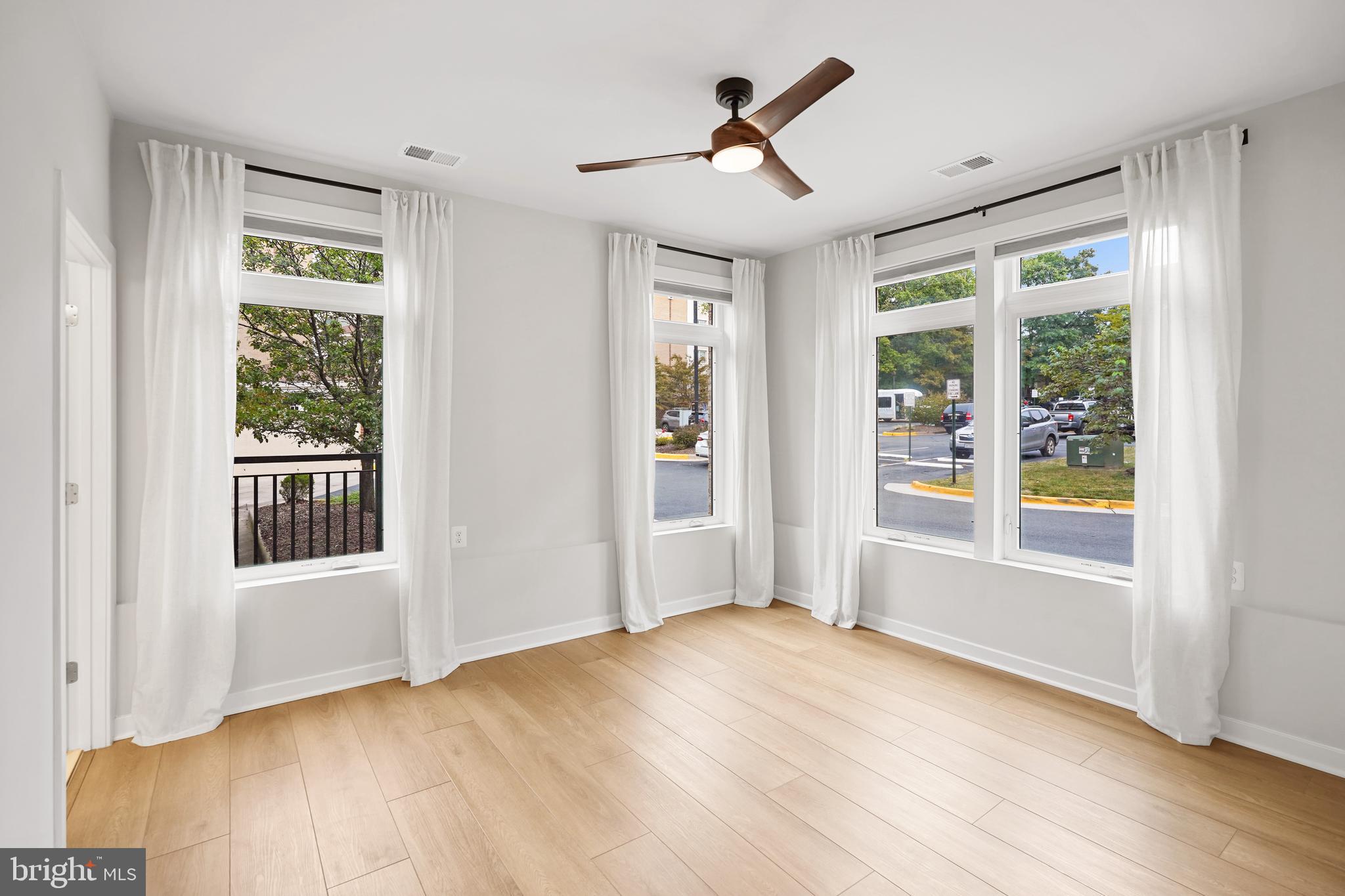1675 Bandit Loop, Unit 107B Reston, VA 20190 - Photo 12 of 36 a view of empty room with wooden floor and fan