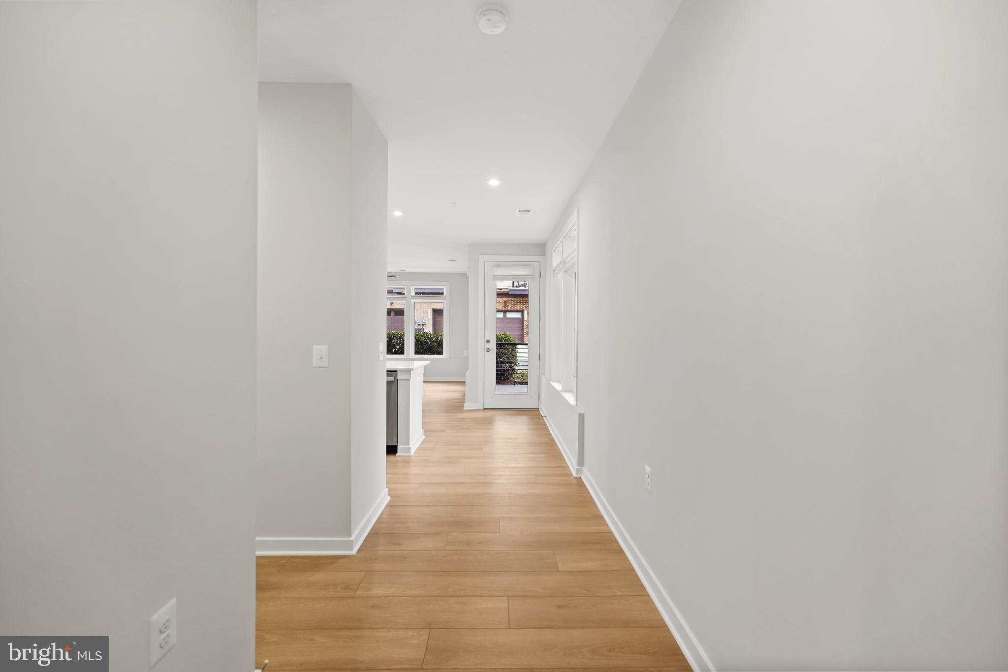 1675 Bandit Loop, Unit 107B Reston, VA 20190 - Photo 16 of 36 a view of a hallway with wooden floor and staircase