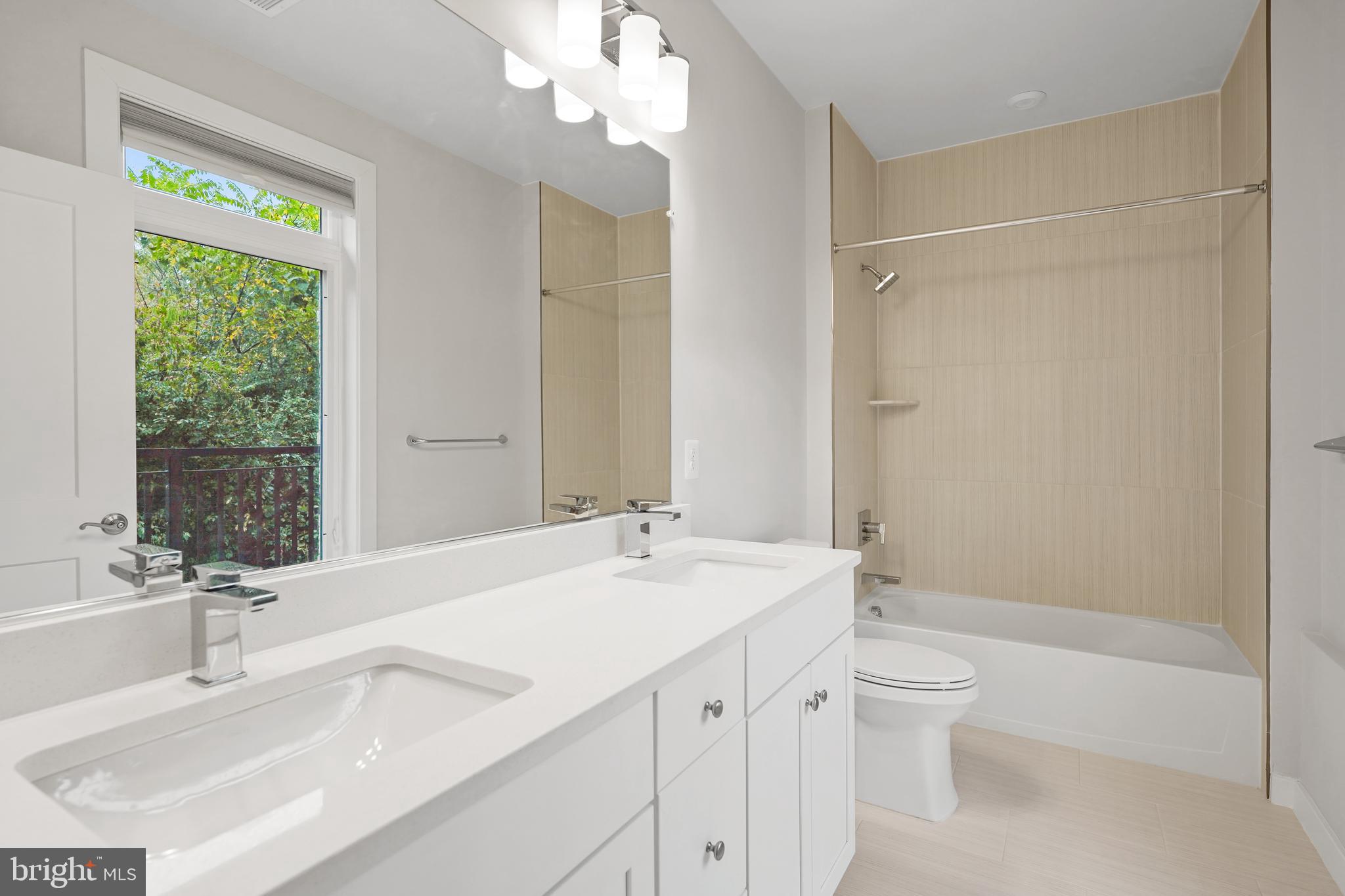 1675 Bandit Loop, Unit 107B Reston, VA 20190 - Photo 20 of 36 a bathroom with a sink a toilet and shower