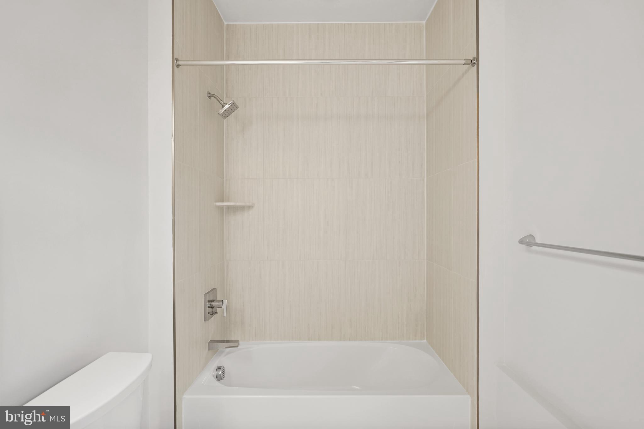 1675 Bandit Loop, Unit 107B Reston, VA 20190 - Photo 21 of 36 a bathroom with a bathtub