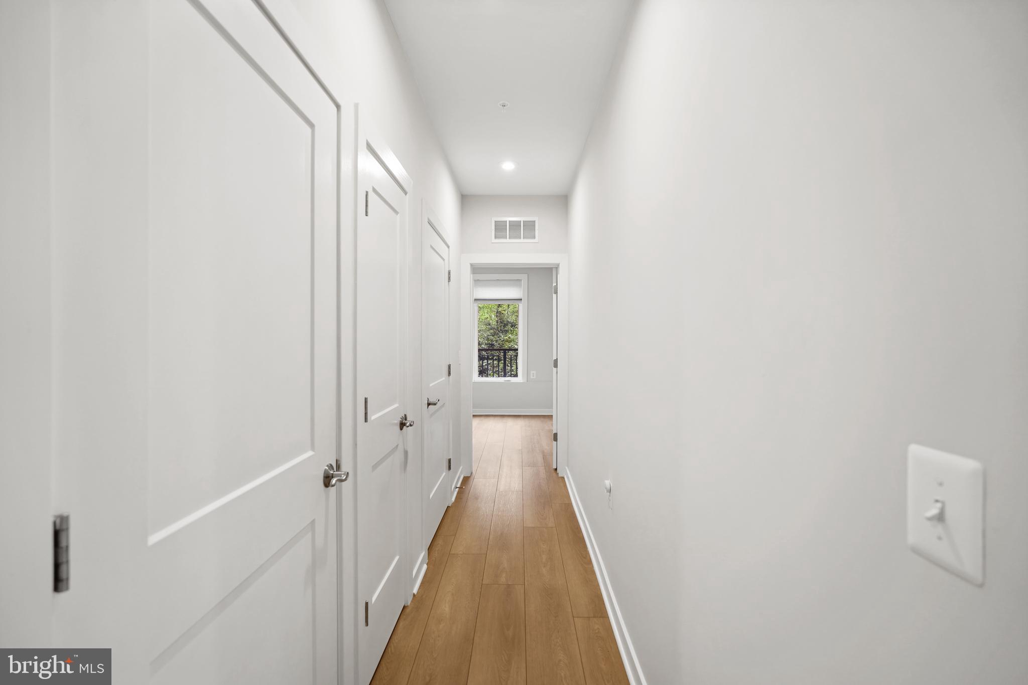 1675 Bandit Loop, Unit 107B Reston, VA 20190 - Photo 22 of 36 a view of a hallway with wooden floor