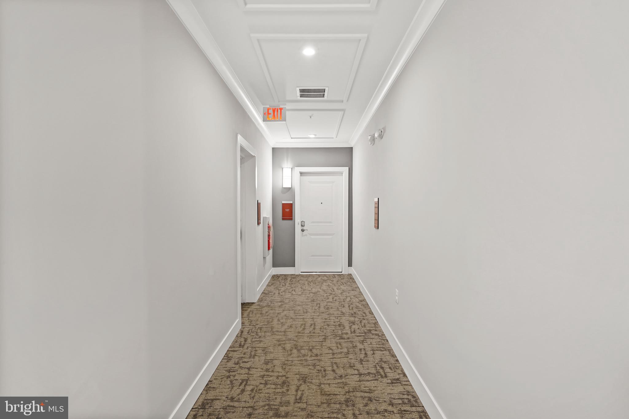 1675 Bandit Loop, Unit 107B Reston, VA 20190 - Photo 26 of 36 a view of a hallway with wooden floor and staircase