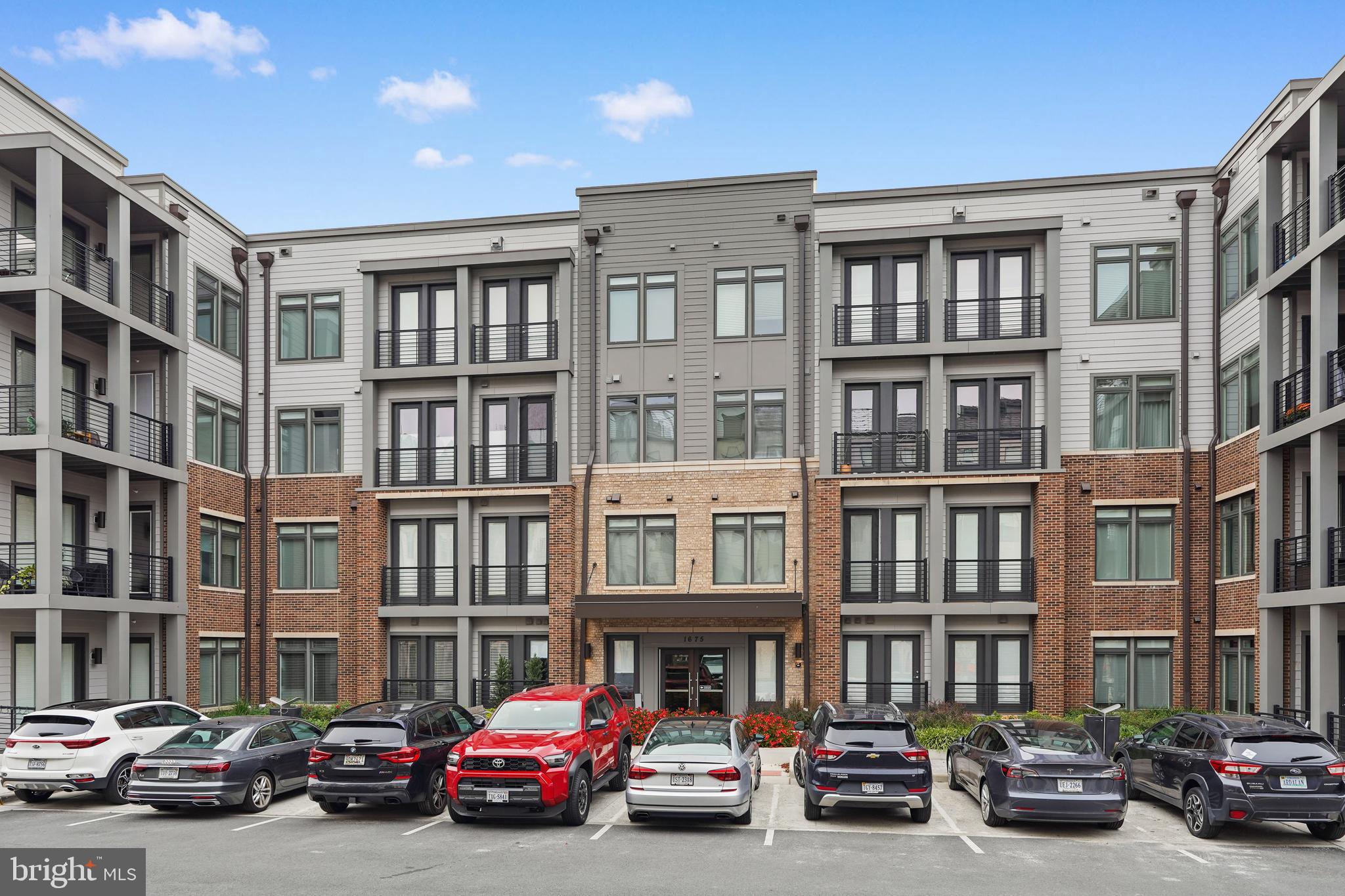 1675 Bandit Loop, Unit 107B Reston, VA 20190 - Photo 31 of 36 a view of a car parked in front of a building