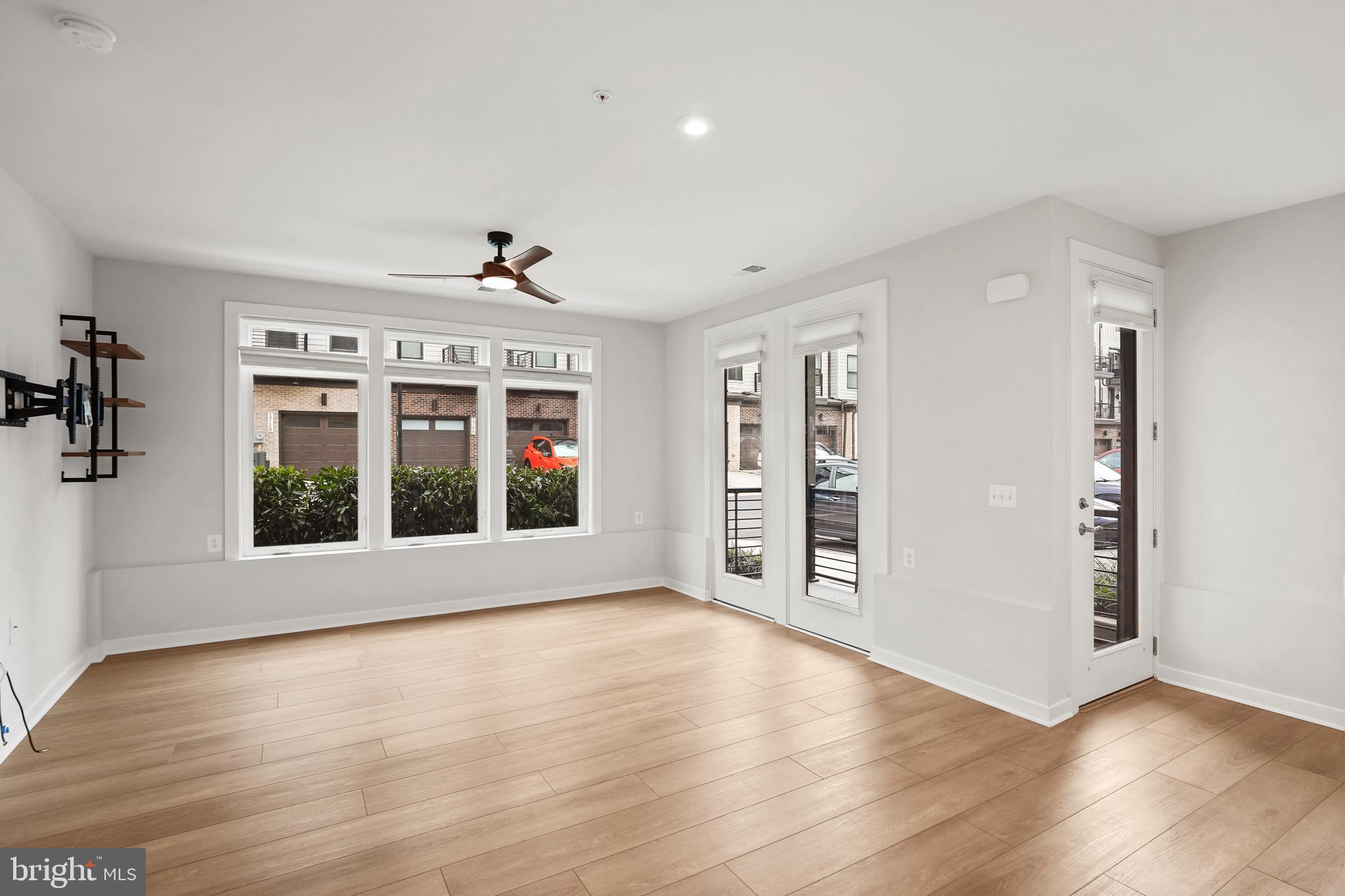 1675 Bandit Loop, Unit 107B Reston, VA 20190 - Photo 4 of 36 wooden floor in an empty room with a window