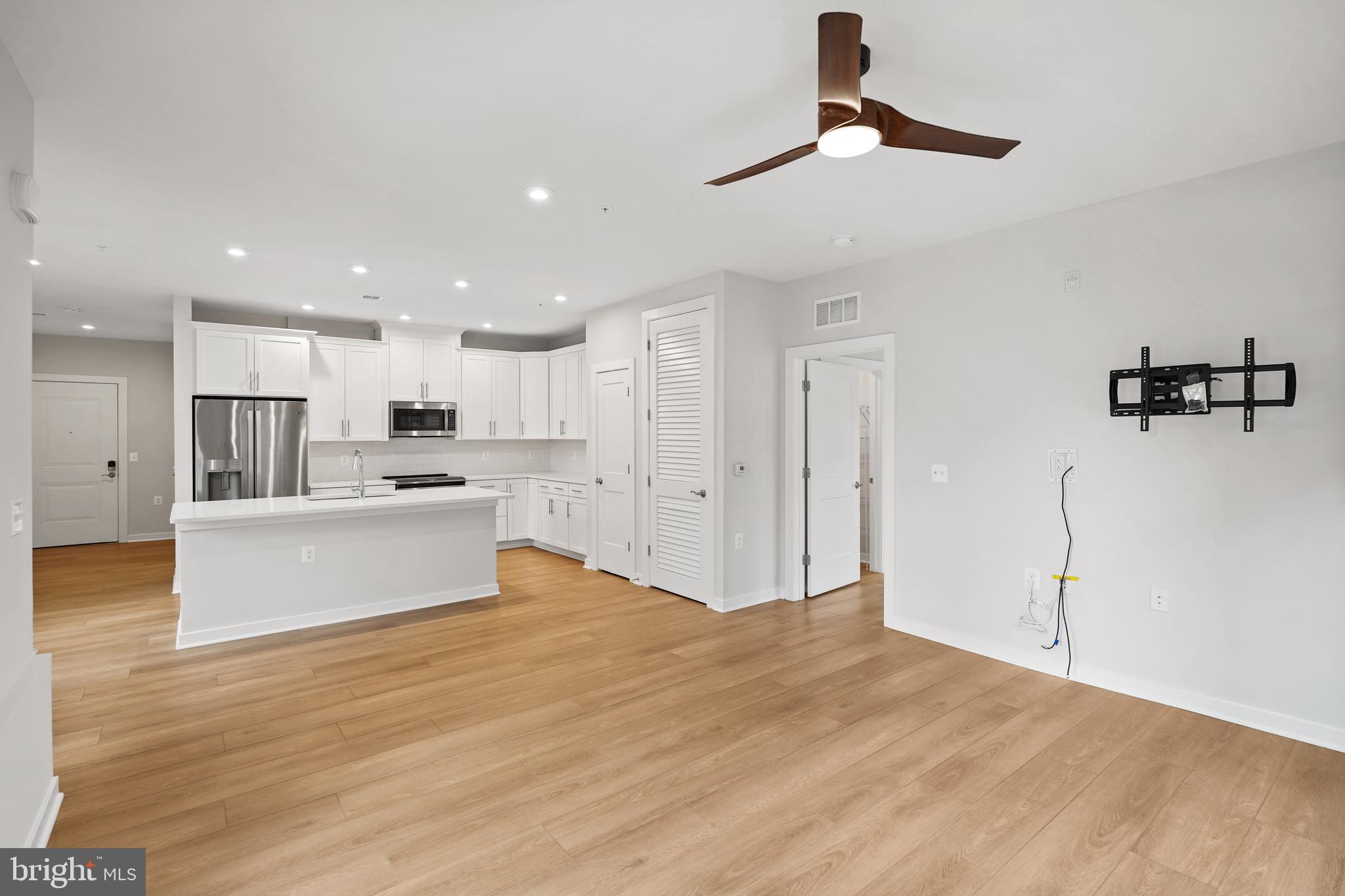 1675 Bandit Loop, Unit 107B Reston, VA 20190 - Photo 8 of 36 a view of kitchen with kitchen island wooden floor center island and stainless steel appliances